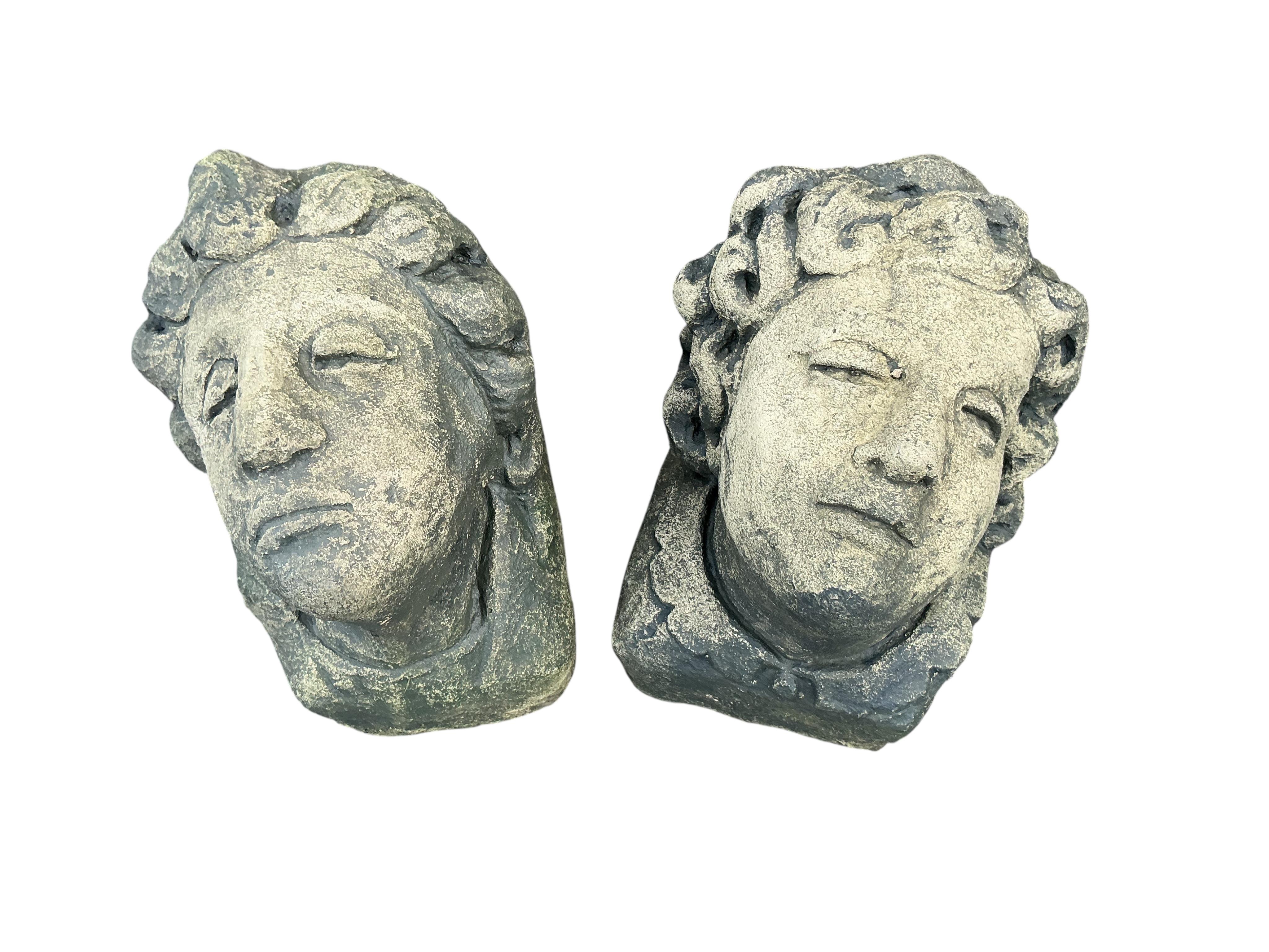 A pair of stone mask corbels, height 22cm